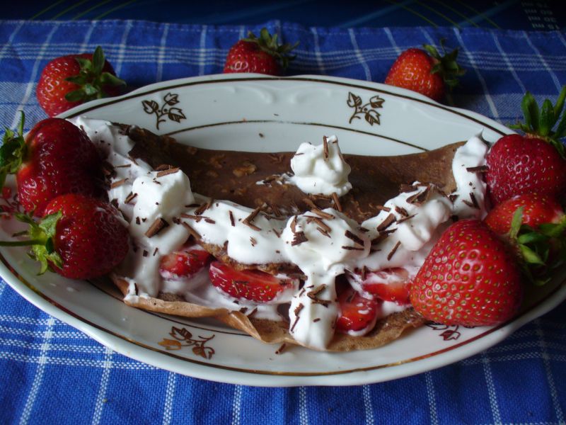 Naleśniki z bitą śmietaną i kawałkami truskawek