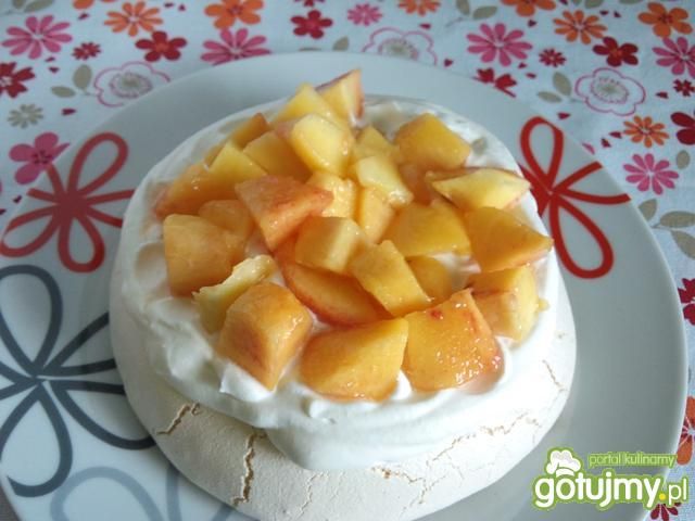 Pavlova z bitą śmietaną i brzoskwiniami Pavlova z bitą śmietaną i brzoskwiniami