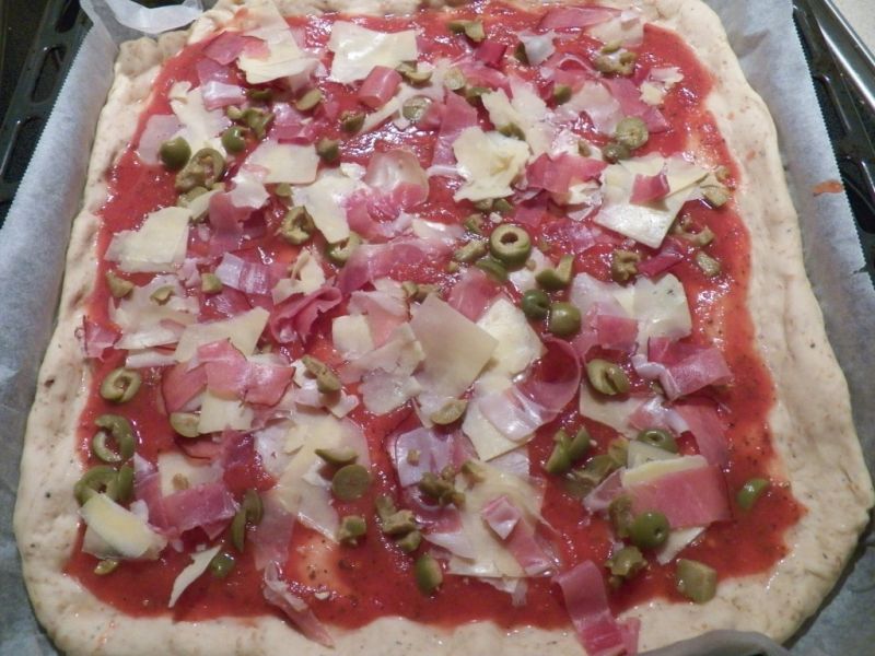 Pełnoziarnista pizza z serem szynką i oliwkami 